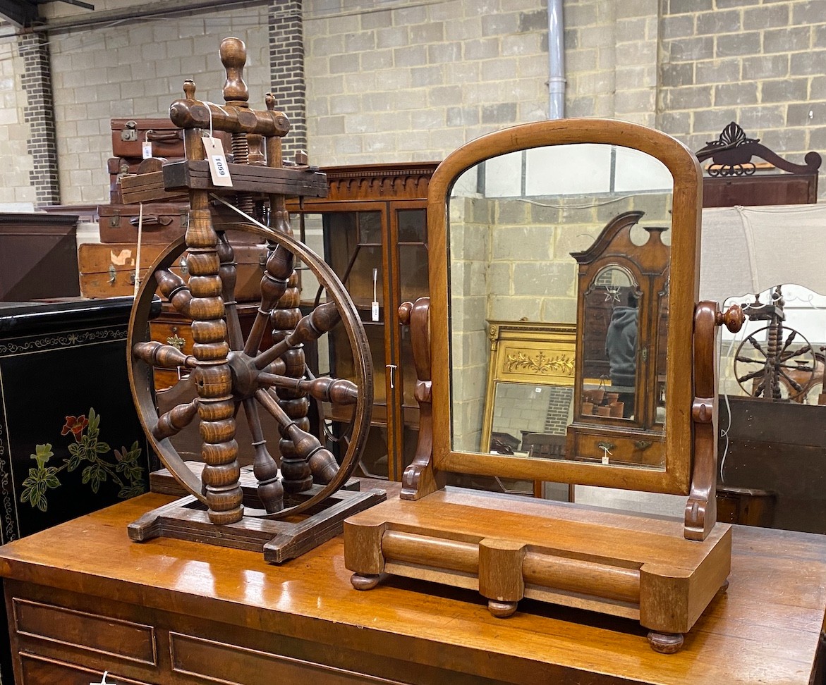 A Provincial turned beech spinning wheel and a Victorian mahogany toilet mirror, larger height 74cm
